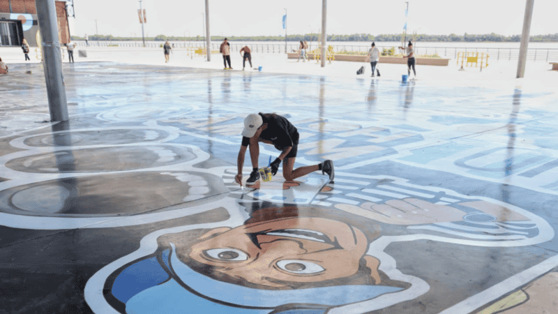 Los artistas trabajan sobre el suelo en el laqueado del mural Río Arriba. (Foto: Alan Monzón / Rosario3)